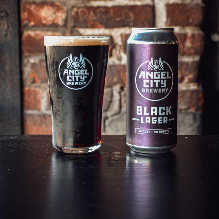 A 16oz. can of Black Lager next to a pint glass of the same beer