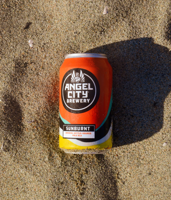 12oz. can of Sunburnt Imperial Sour Ale in the sand