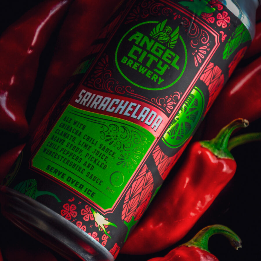 A 16oz can of Srirachelada on a bed of Fresno Chili Peppers and limes