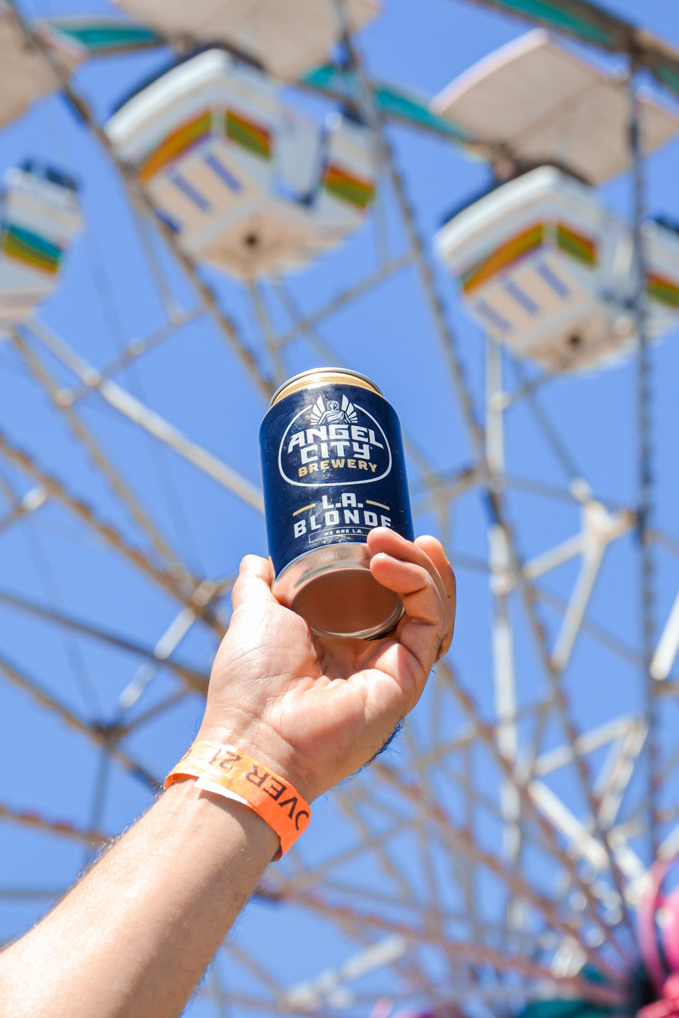 Can of L.A. Blonde being hoisted in air in front of ferris wheel at the California State Fair