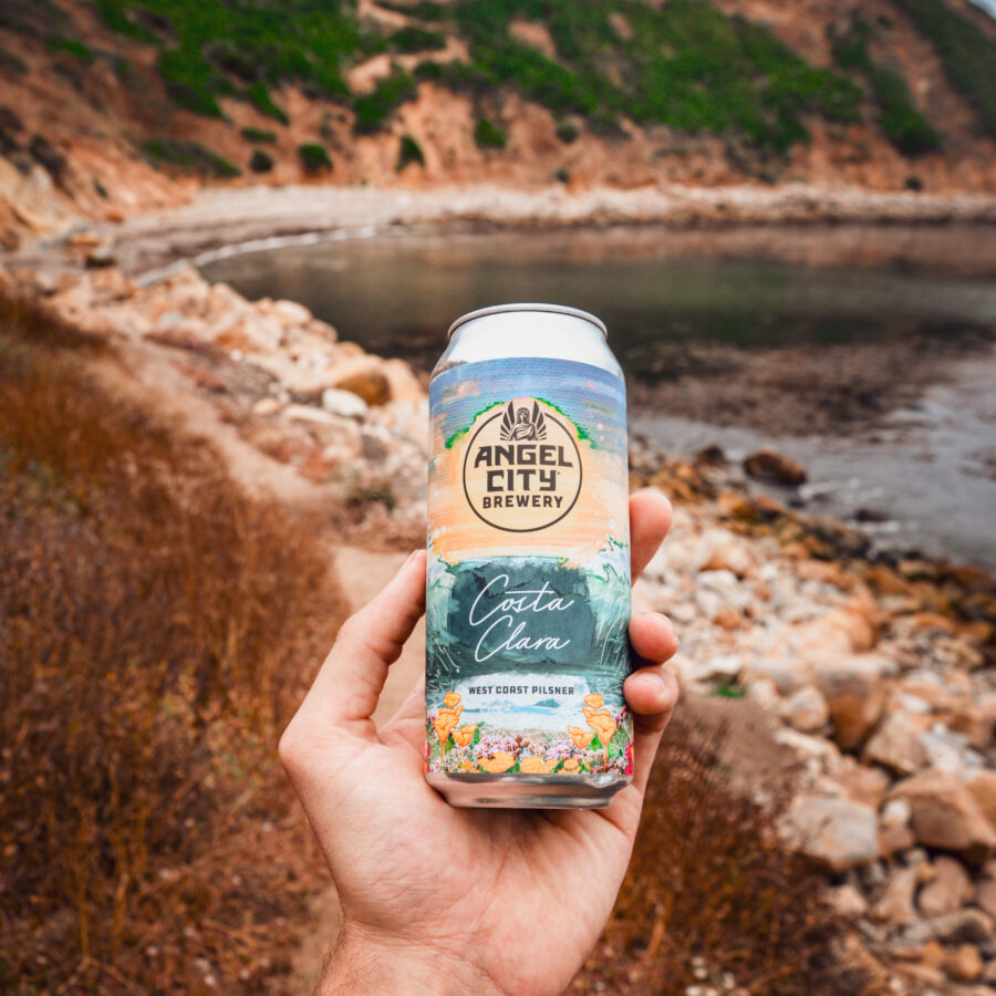 A 16oz. can of Costa Clara West Coast Pilsner at the beach