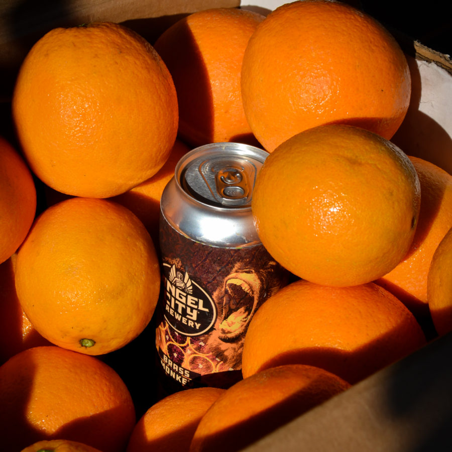 16oz can of Brass Monkey in a box of oranges