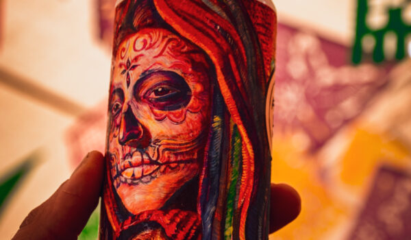 A can of Olvera Street Mexican Lager featuring art by Elisa Torres