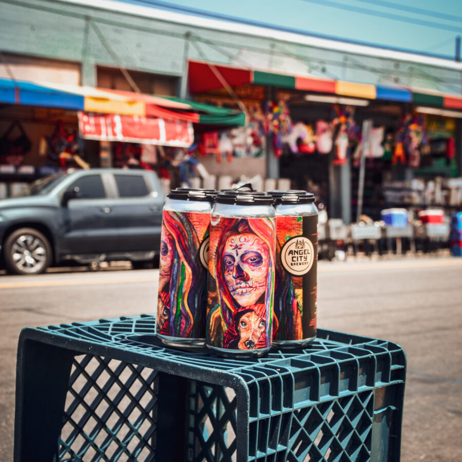 4-pack of Olvera St. Mexican Lager cans featuring art by Elisa Torres