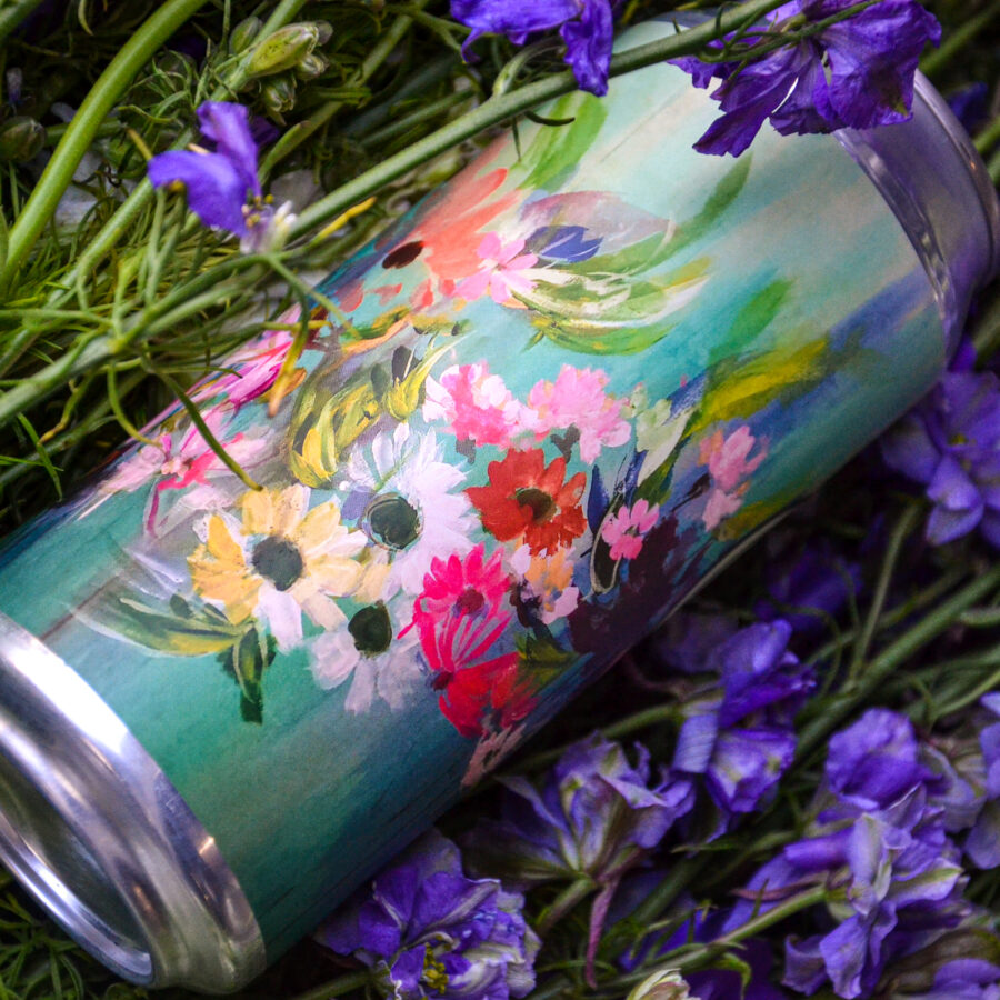 16oz. can of Biere de Mars in a bed of flowers. Can art by Colleen Sandland.